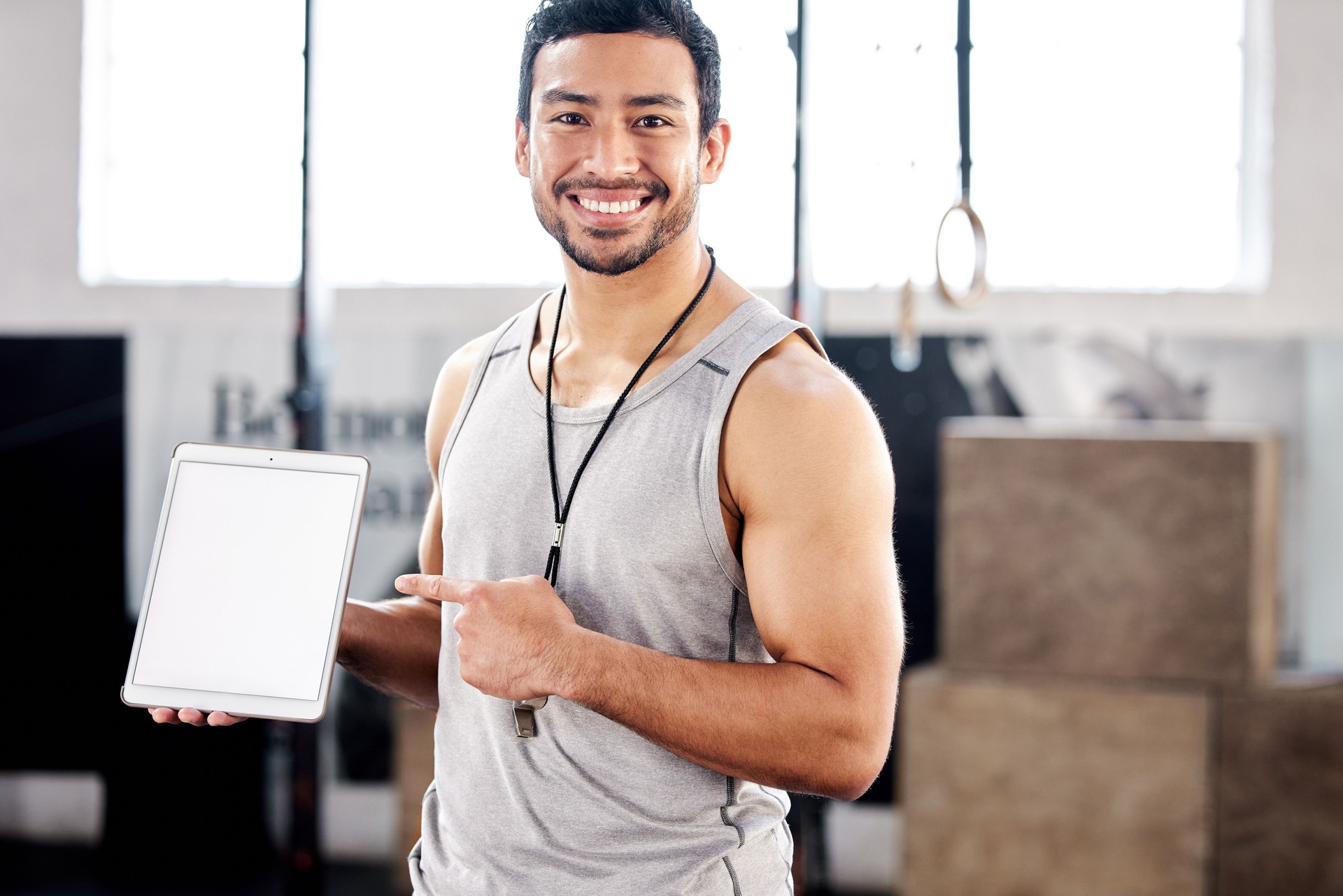 Shot of a handsome young man using a digital tablet at the gym